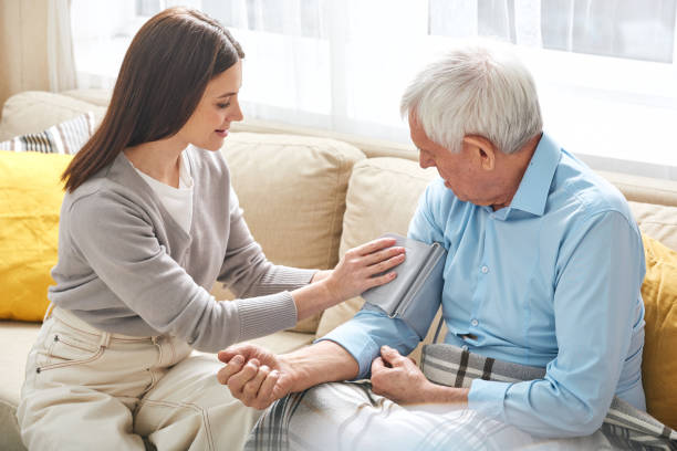 istock Nurse taking pressure of elderly man at home 1210473833