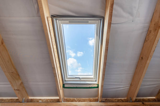 istock Plastic mansard window with double glasses and clear view on sky 1210475714