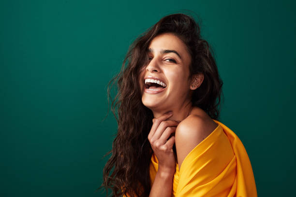 True beauty cannot be described Shot of a beautiful young woman posing against a green background indian woman laughing stock pictures, royalty-free photos & images