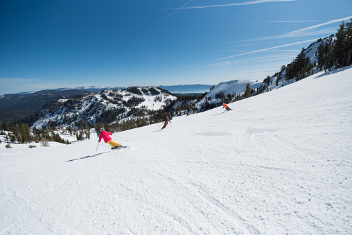 Skiers play and rip lines in Truckee, California mountains