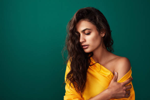 Shot of a beautiful young woman posing against a coloured background
