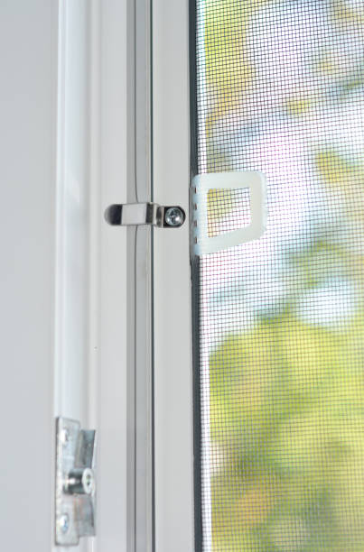 istock Close-up on a mosquito wire screen installation on a window for insects protection. 1210479532