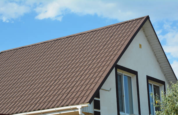 istock Two storey simple house with a-frame metal tiled roof and white plastic rain gutter. 1210484383