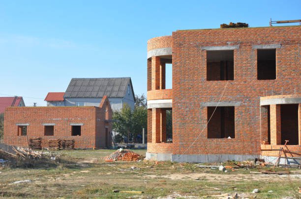 istock Building residential brick house construction exterior without roofing. 1210484520