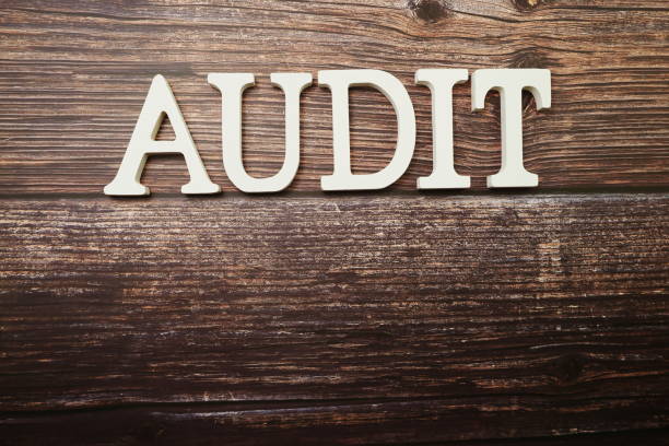 istock Audit alphabet letters on wooden background 1210485109