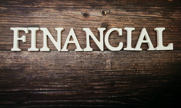 istock Financial alphabet letter on wooden background 1210485381