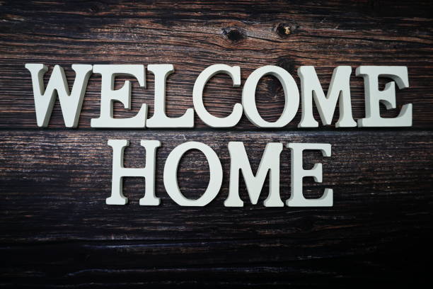Welcome Home alphabet letter on wooden background