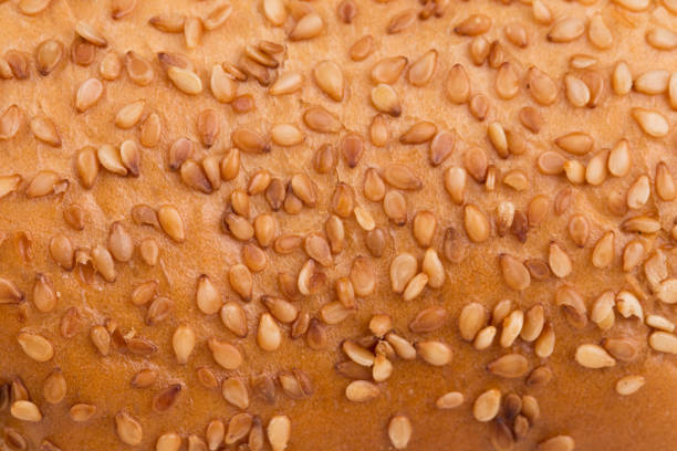 istock Fragment of a bun with sesame seeds. 1210488038