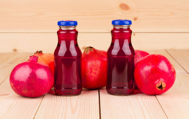 istock Still life with pomegranate juice and ripe pomegranates. 1210489106
