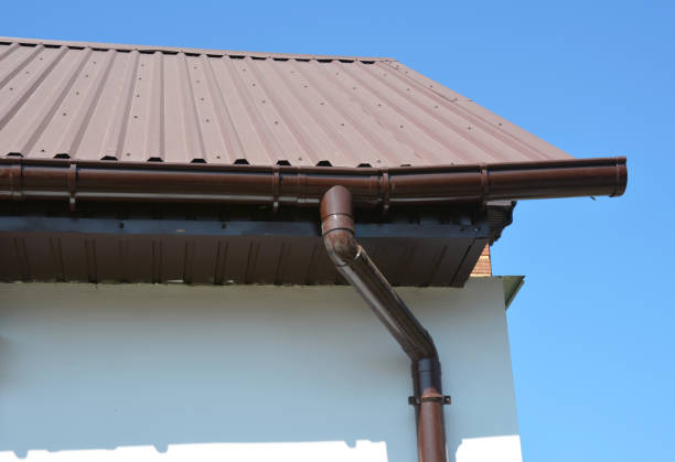 istock House metal roof corner with plastic rain gutter pipeline system. 1210489111