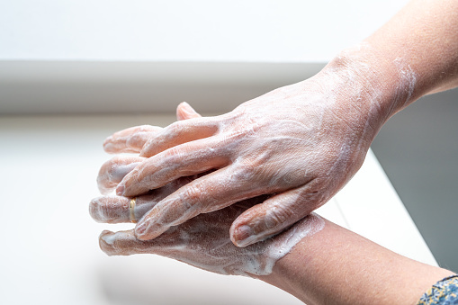 Total hand washing : woman washing her hands to avoid diseases like coronavirus