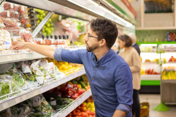 istock Young man shopping in grocery store 1210492448