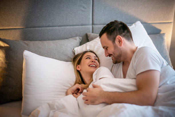 istock Happy couple sleeping in bed at home 1210492902