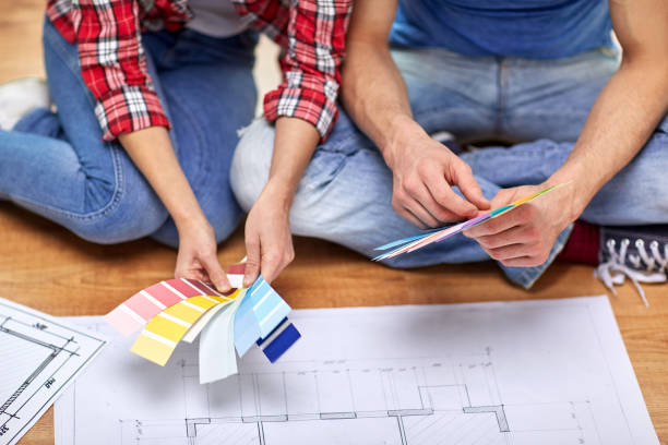 istock smiling couple looking at color samples at home 1210493798