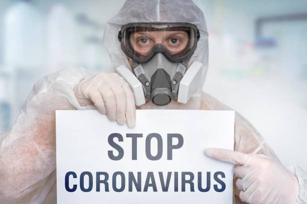 istock Scientist with FFP3 respirator mask is showing STOP gesture 1210493841