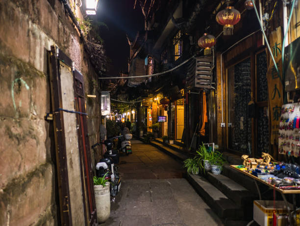 Tourist walking in Hotel Alley in the evening of  fenghuang old town.phoenix ancient town or Fenghuang County is a county of Hunan Province, China fenghuang,Hunan/China-16 October 2018:Tourist walking in Hotel Alley in the evening of  fenghuang old town.phoenix ancient town or Fenghuang County is a county of Hunan Province, China fenghuang county photos stock pictures, royalty-free photos & images