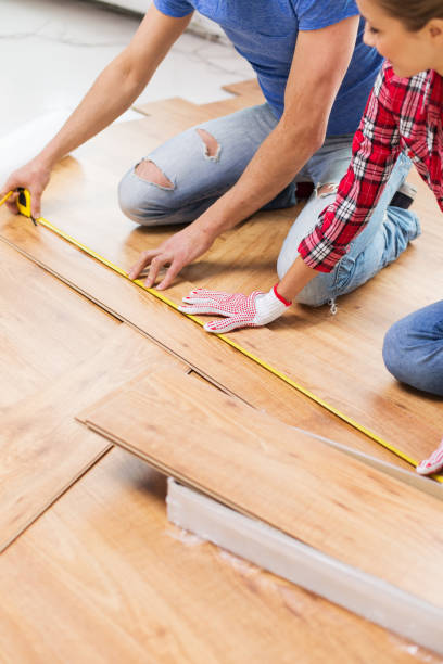 istock smiling couple measuring wood flooring 1210493889