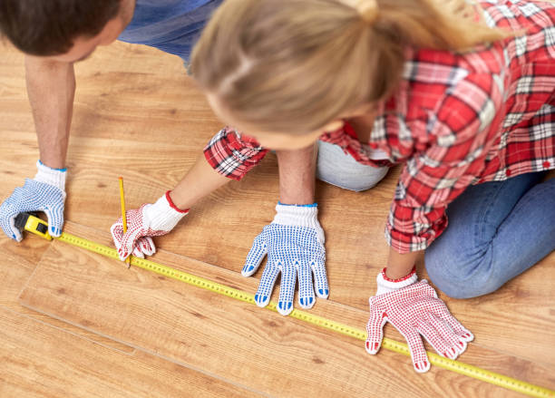 istock smiling couple measuring wood flooring 1210493924