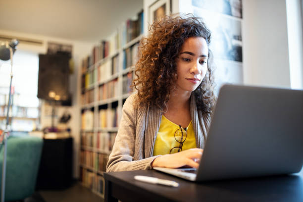 istock Young beautiful student girl working, learning in college library 1210497747