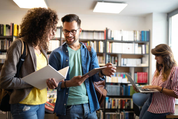 istock Group of college students studying in the school library 1210498329