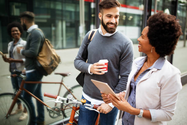 istock Business people discussing and smiling while walking together outdoor 1210498500