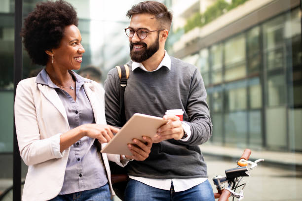 istock Business people discussing and smiling while walking together outdoor 1210498531