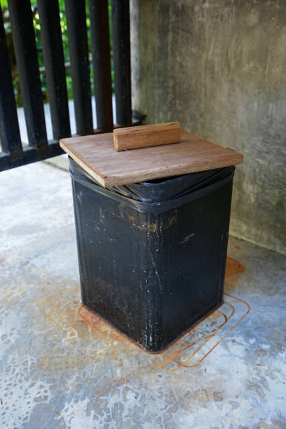 istock Close up black tin trash bin with wooden lids 1210501293