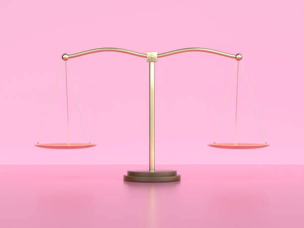 istock gold balance scale pink scene 3d rendering 1210501594
