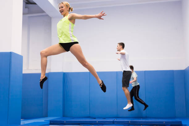 istock Female gymnast jumping on trampoline 1210503050