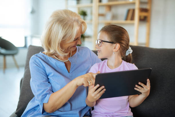 istock Grandma and granddaughter with digital tablet 1210503490