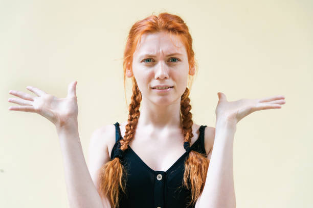 istock Young ginger woman posing on yellow background. 1210503533