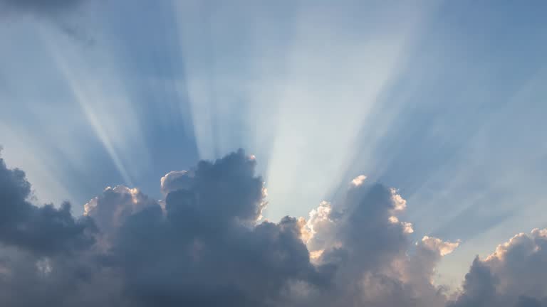 Dramatic sunburst or sun rays or god light beam through the cloud – Time Lapse