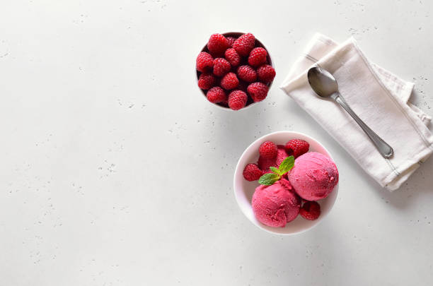 istock Raspberry ice cream scoop with fresh raspberries in bowl and fresh raspberries 1210507798