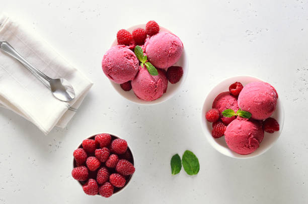 istock Raspberry ice cream scoop with fresh raspberries in bowl and fresh raspberries 1210507827