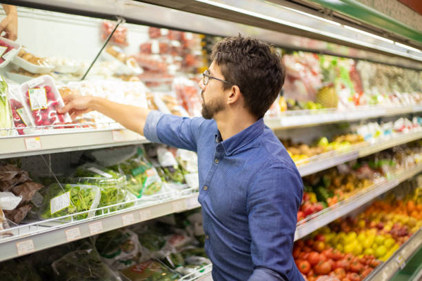 istock Focused young man shopping in grocery store 1210508186