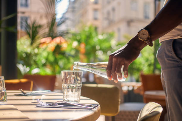 istock Man is pouring water to the glass 1210508805