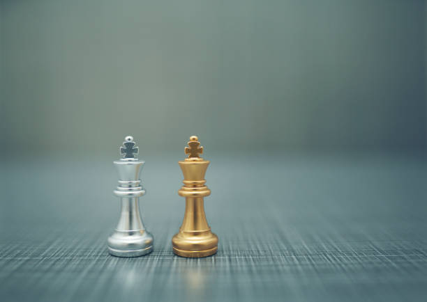 istock Close up golden chess pieces on dark background 1210509126