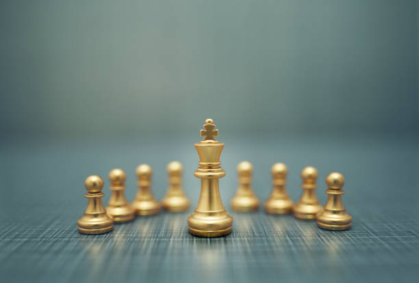 istock Close up golden chess pieces on dark background 1210509150