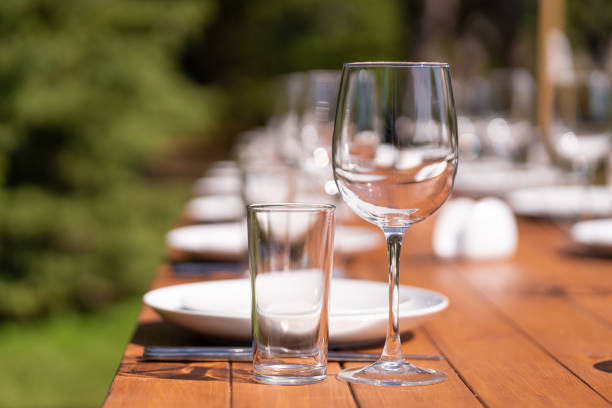istock Served wooden table without a tablecloth. Cafe in the open air park 1210510877