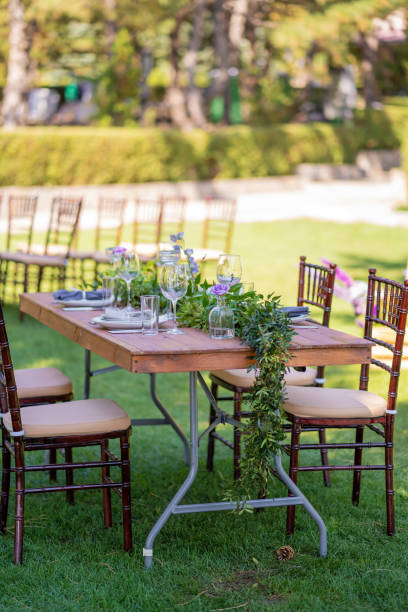 istock Preparing for an open-air party. Decorated with fresh flowers served tables. Table number. Decoration Details 1210510993