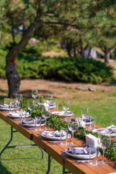 istock Preparing for an open-air party. Decorated with fresh flowers served tables. Table number. Decoration Details 1210511019