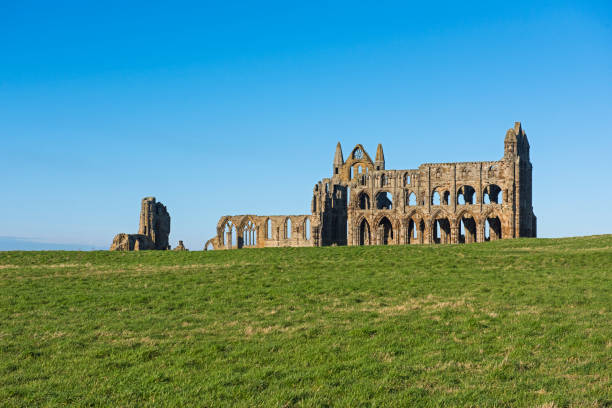 istock Ancient abbey ruins with gothic architecture in rural landscape 1210511136