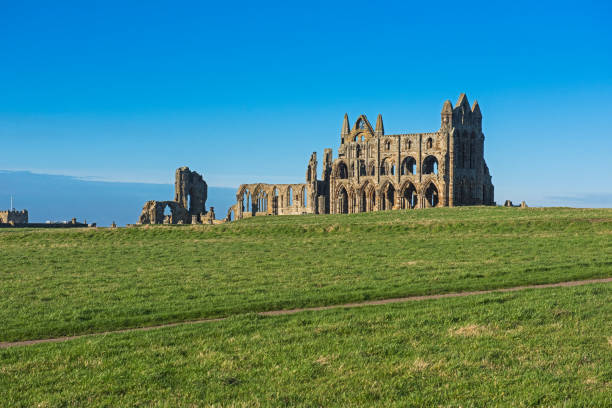istock Ancient abbey ruins with gothic architecture in rural landscape 1210511203