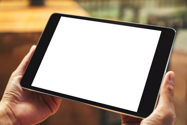 istock a woman sitting and holding black tablet pc with blank white desktop screen 1210512619