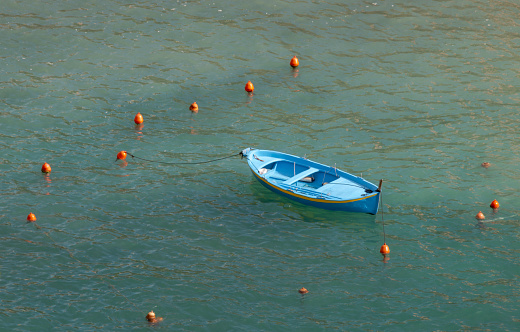 Blue little anchored boat near Vernazza, Cinque Terre, during spring.