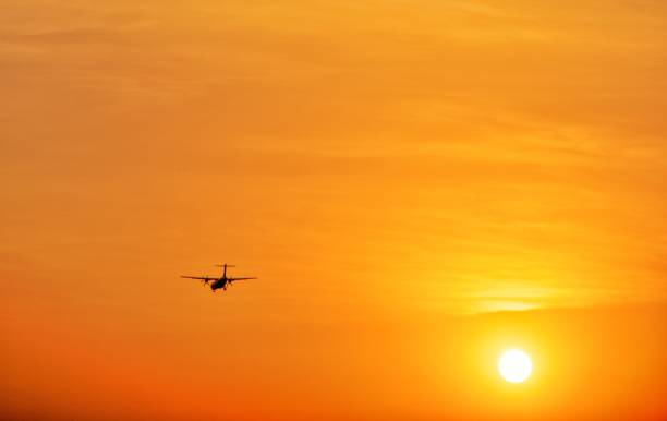 istock Airplane Against The Sun 1210513907