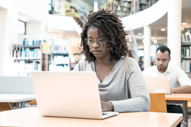 istock Serious African American student working on research paper 1210515483