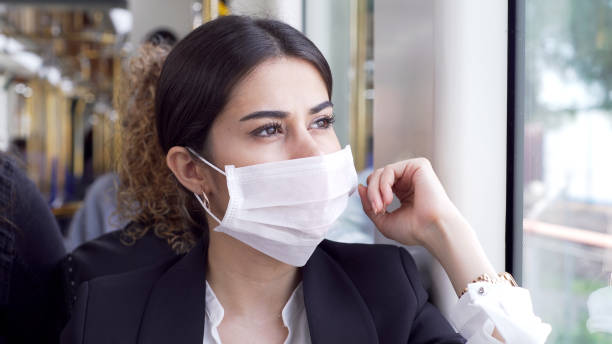 istock Businesswoman wearing a mask while traveling 1210516081
