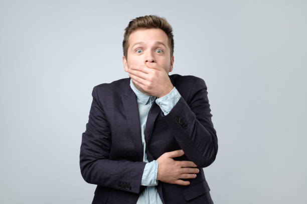 istock Surprised young men covering his mouth by hand 1210516644