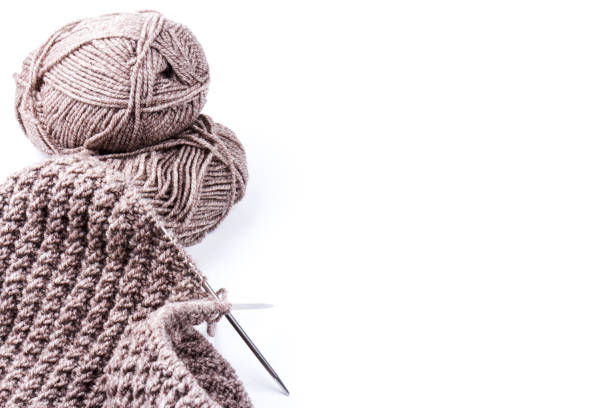 istock knitting needles and woolen threads on white background. natural wool knitting background 1210518854